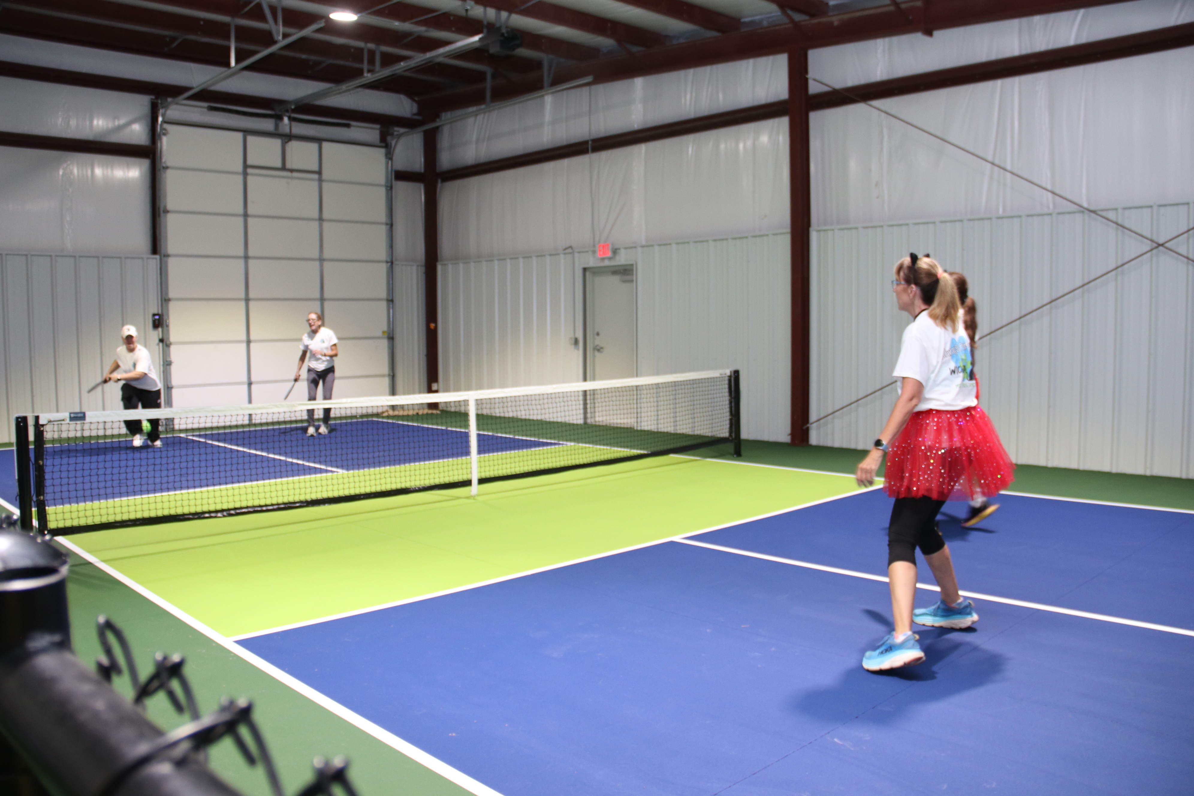 Doubles pickleball game in action at Pickle 4 Paws